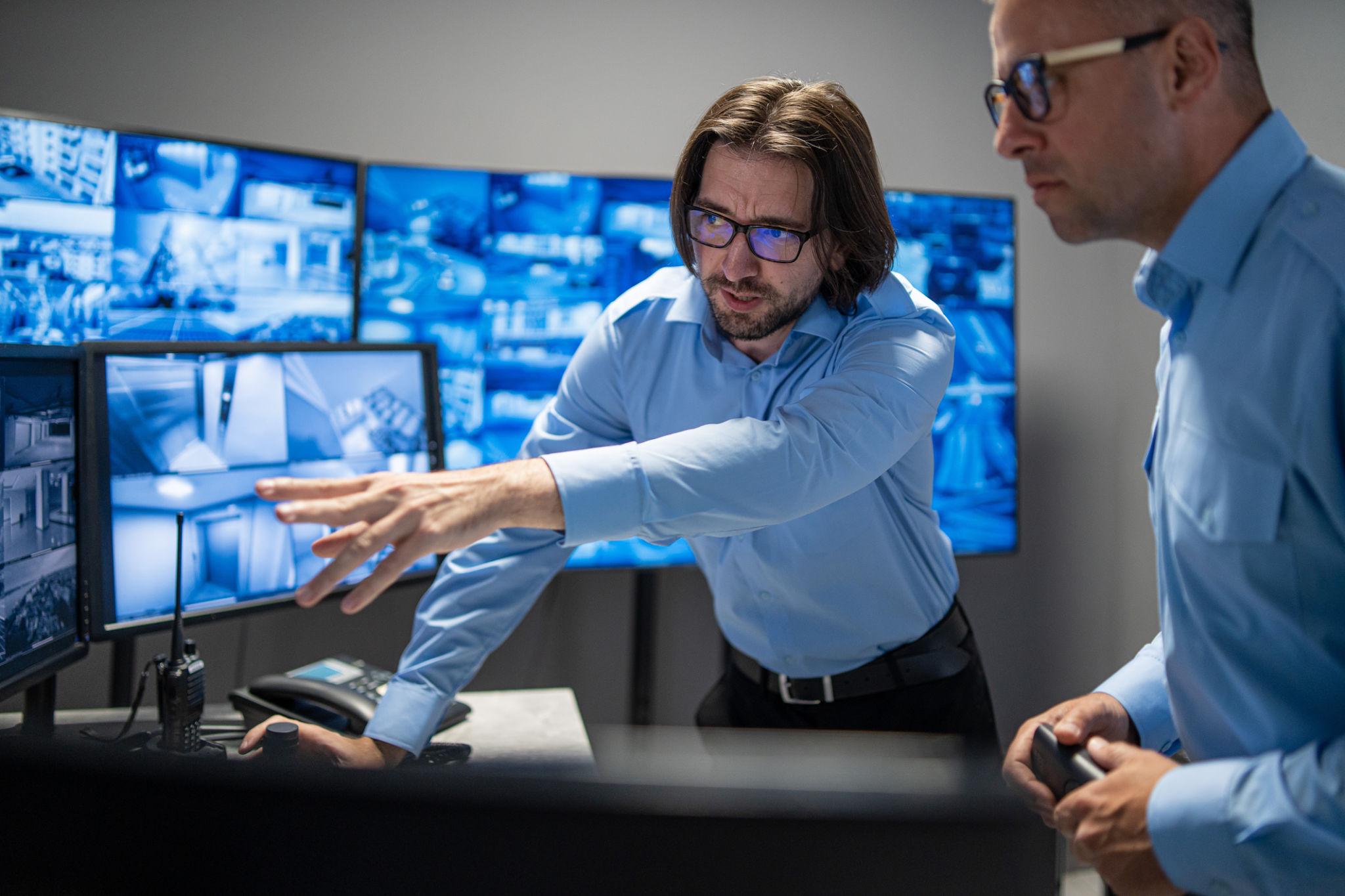 Security operations professionals reviewing live surveillance intelligence